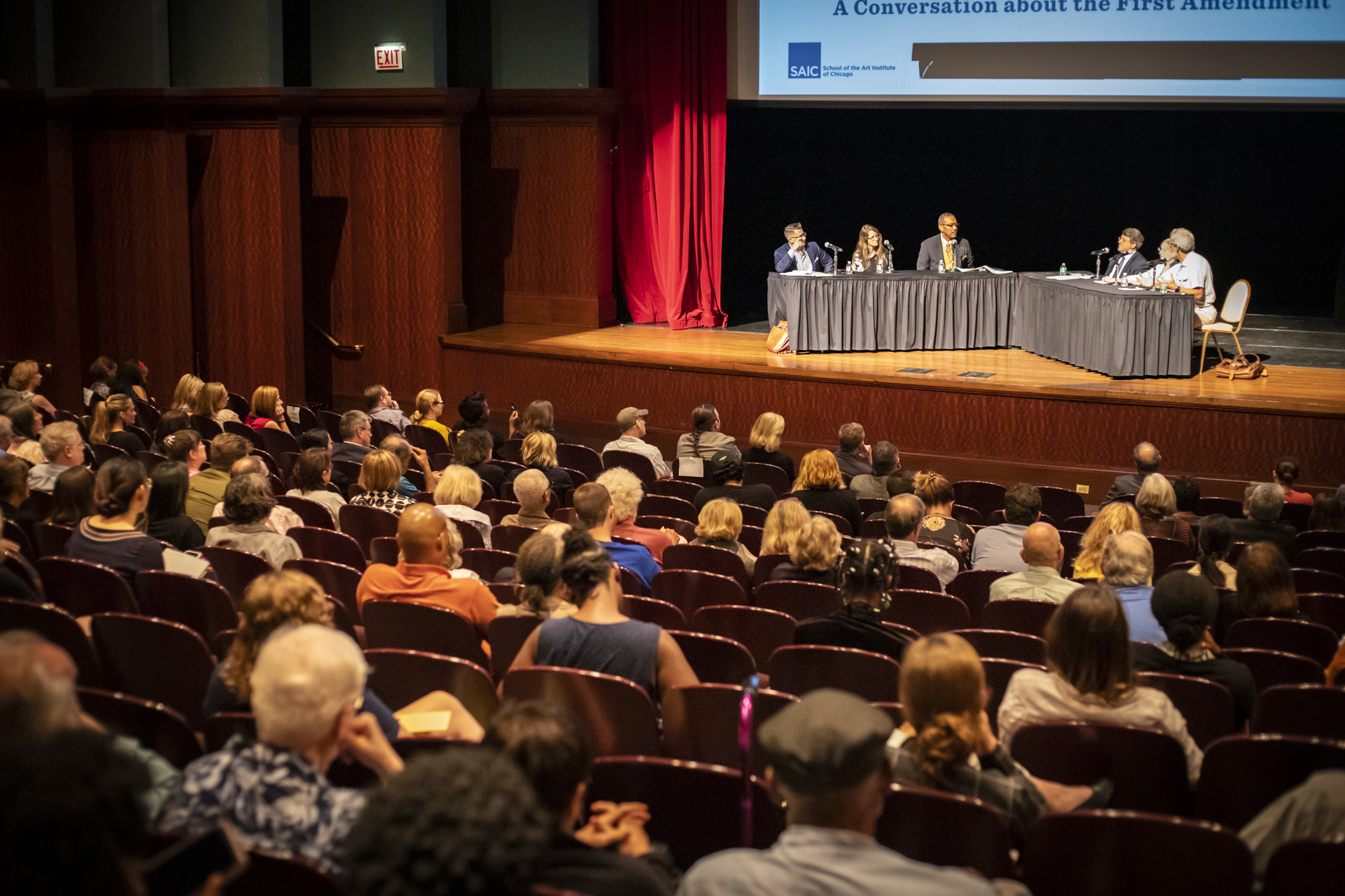 Audience and stage view of panelists at First Amendment Conversation